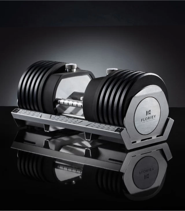 100lb black adjustable dumbbell set on a sleek platform.