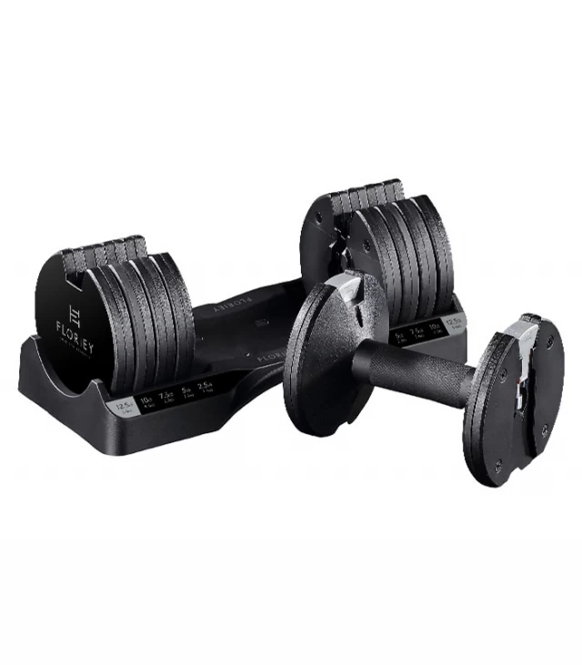 12.5lb adjustable dumbbells resting in their storage cradle