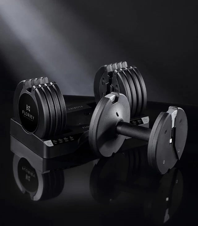 25lb black adjustable dumbbells on a reflective surface, perfect for home gyms